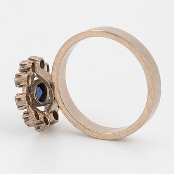 Oval faceted sapphire and brilliant-cut diamond ring.