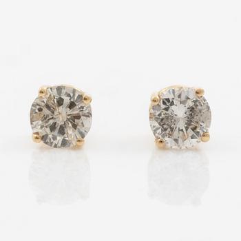 A pair of 14K gold earrings with round brilliant-cut diamonds.
