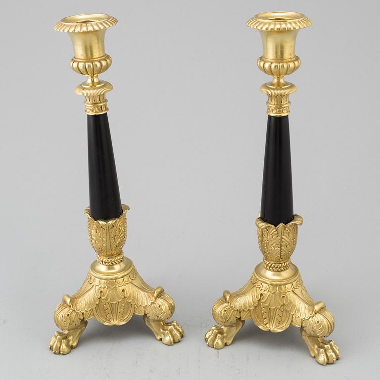 A pair of Empire style candlesticks, 20th Century.