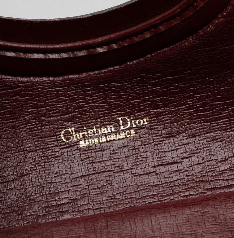 A red monogram canvas handbag by Christian Dior.