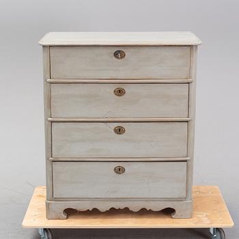 A painted chest of drawers from around the year 1900.