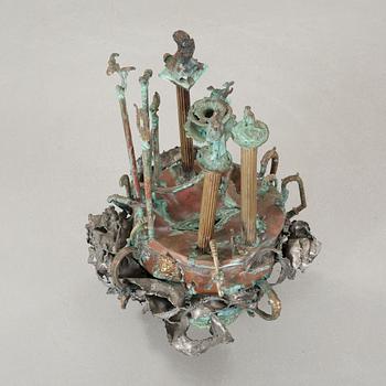 a metal sculpture, signed and dated 1980.
