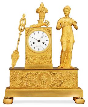 634. A French Empire gilt bronze mantel clock by Flocard.