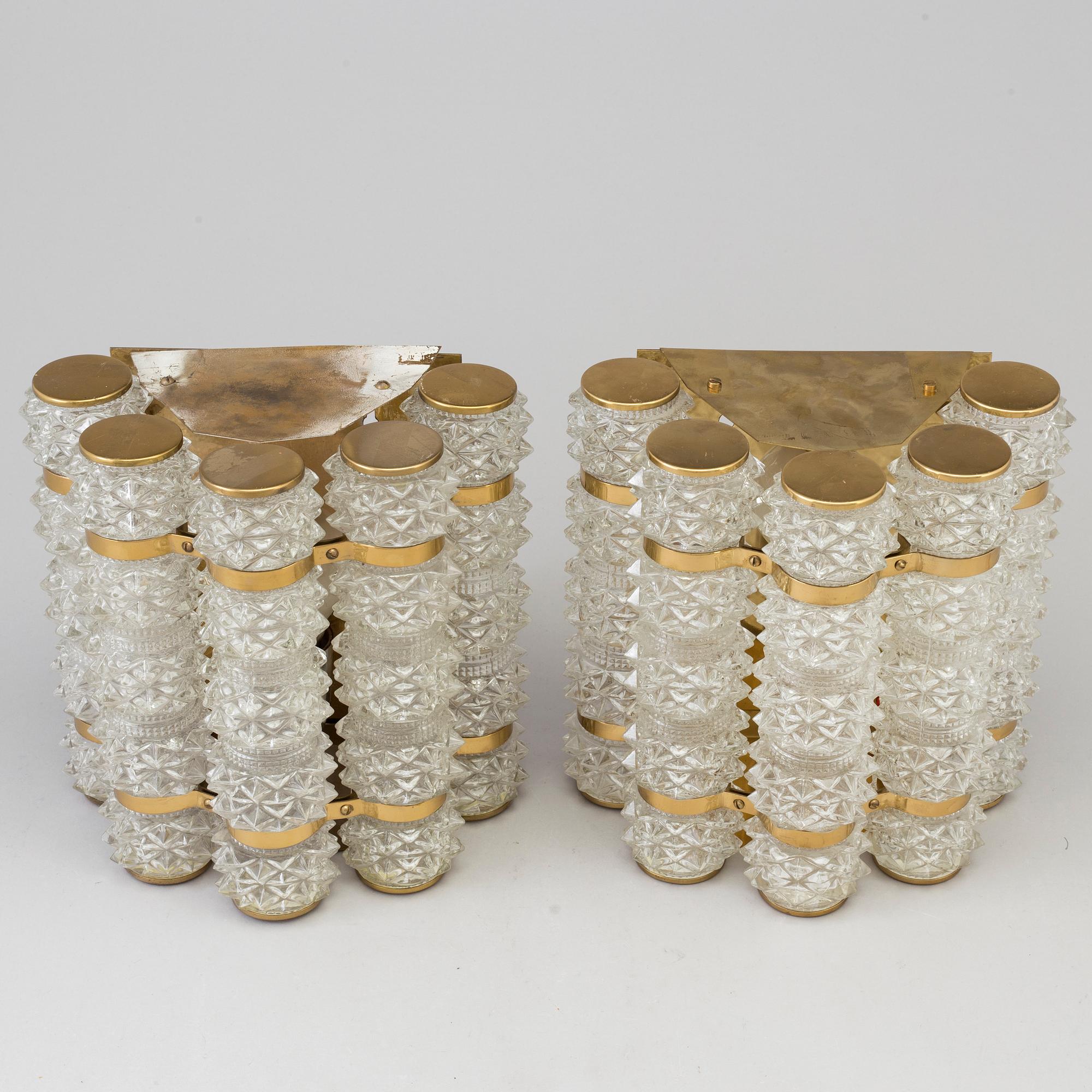 A pair of 1970's glass and brass wall lamps.