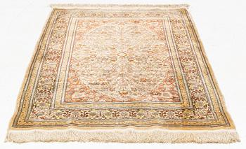 A silk Hereke rug, circa 104 x 70 cm.