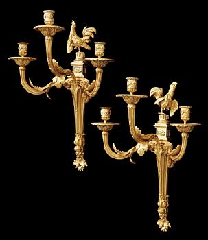 A pair of Louis XVI gilt bronze three-light wall-lights attributed to Jean-Louis Prieur, Paris circa 1770.