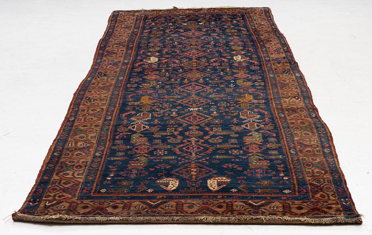 A semi-antique Northwest Persian runner, c. 388 x 94 cm.