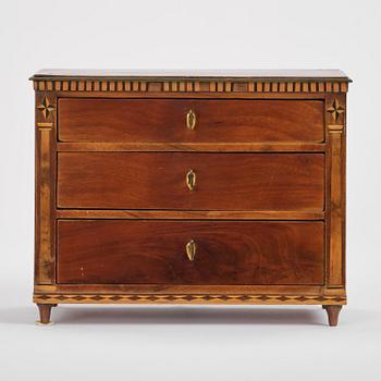 A Northern European mahogany miniature commode, early 19th century.