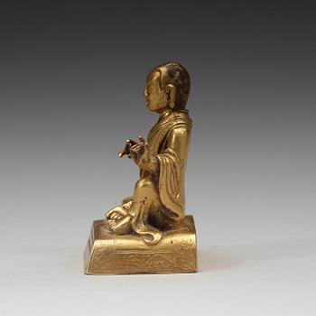 A small gilt-bronze seated Buddhist lama, Tibet, 20th Century.