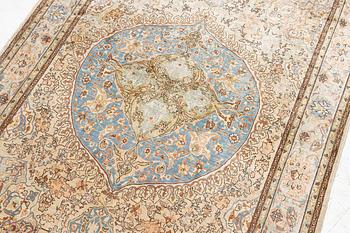 An oriental, silk rug, signed, c. 175 x 125 cm.