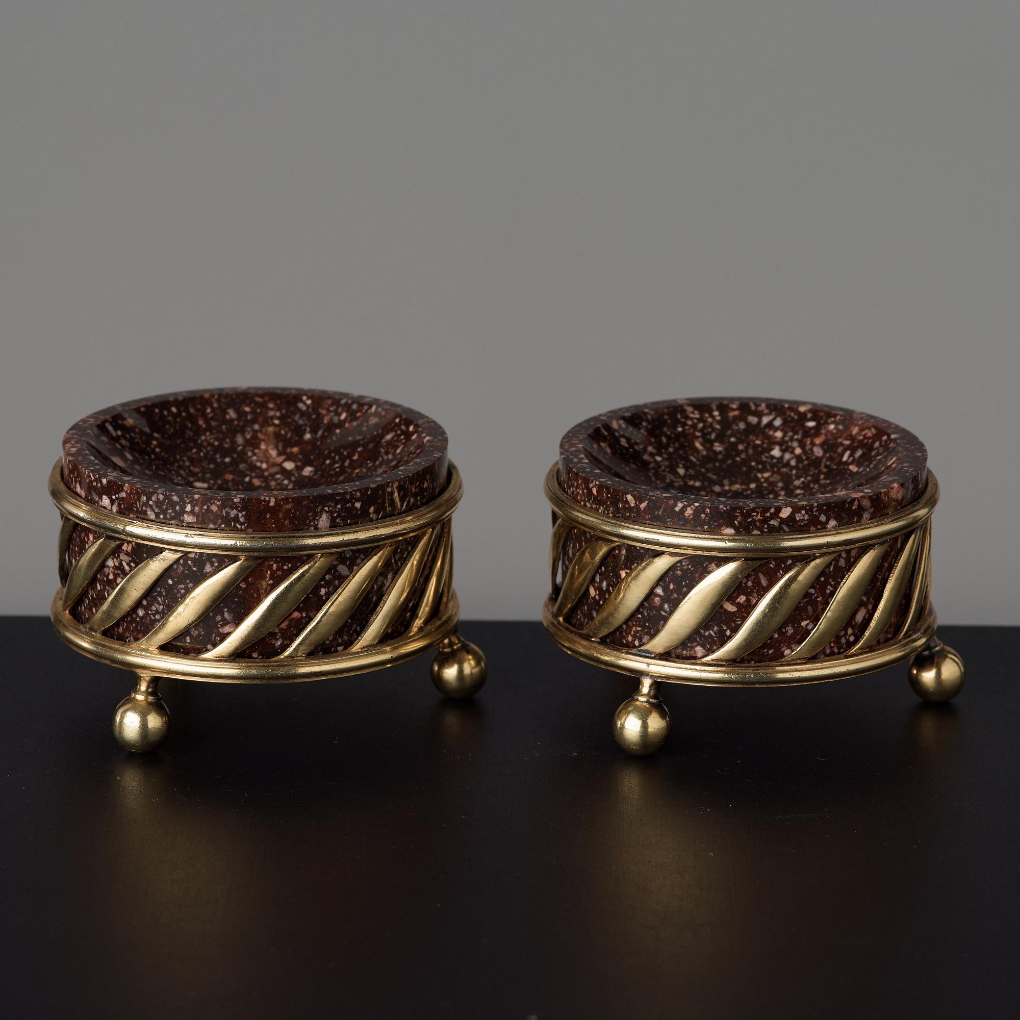 A pair of gilt silver and porphyry salts, by Gustaf Folcker, Stockholm 1827.
