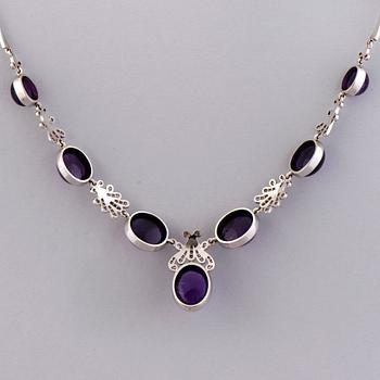 A NECKLACE, BRACELET, EARRINGS and RING, amethysts, diamnonds, 18K white gold and palladium. A. Tillander, 1970s.