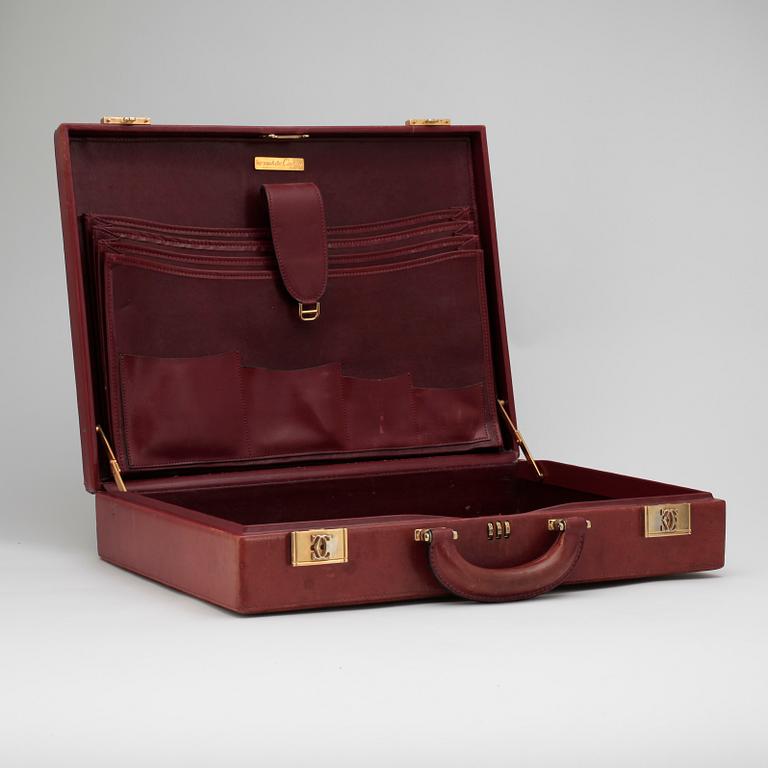 CARTIER, a red leather briefcase.