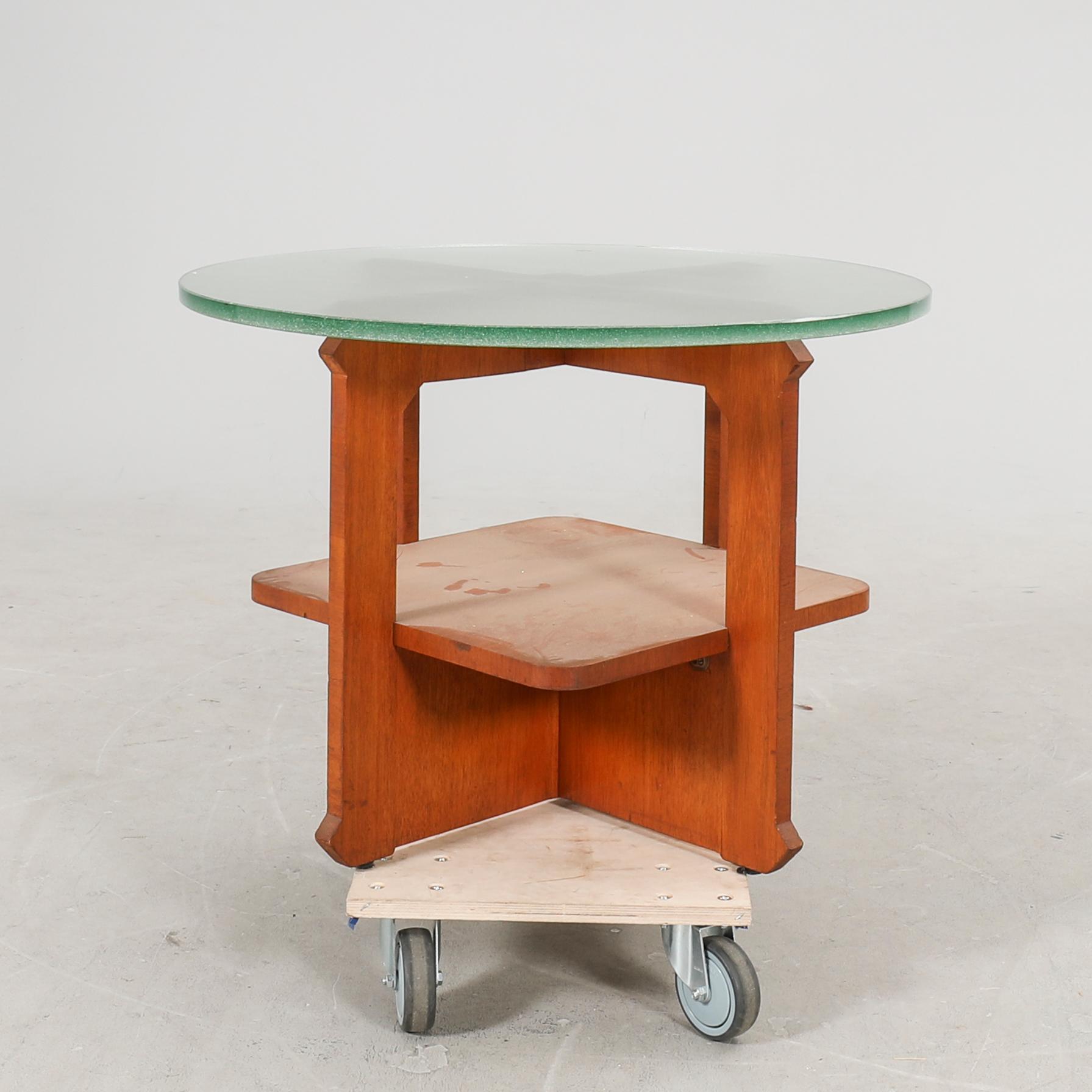 A 1940s wood and glass coffee table.
