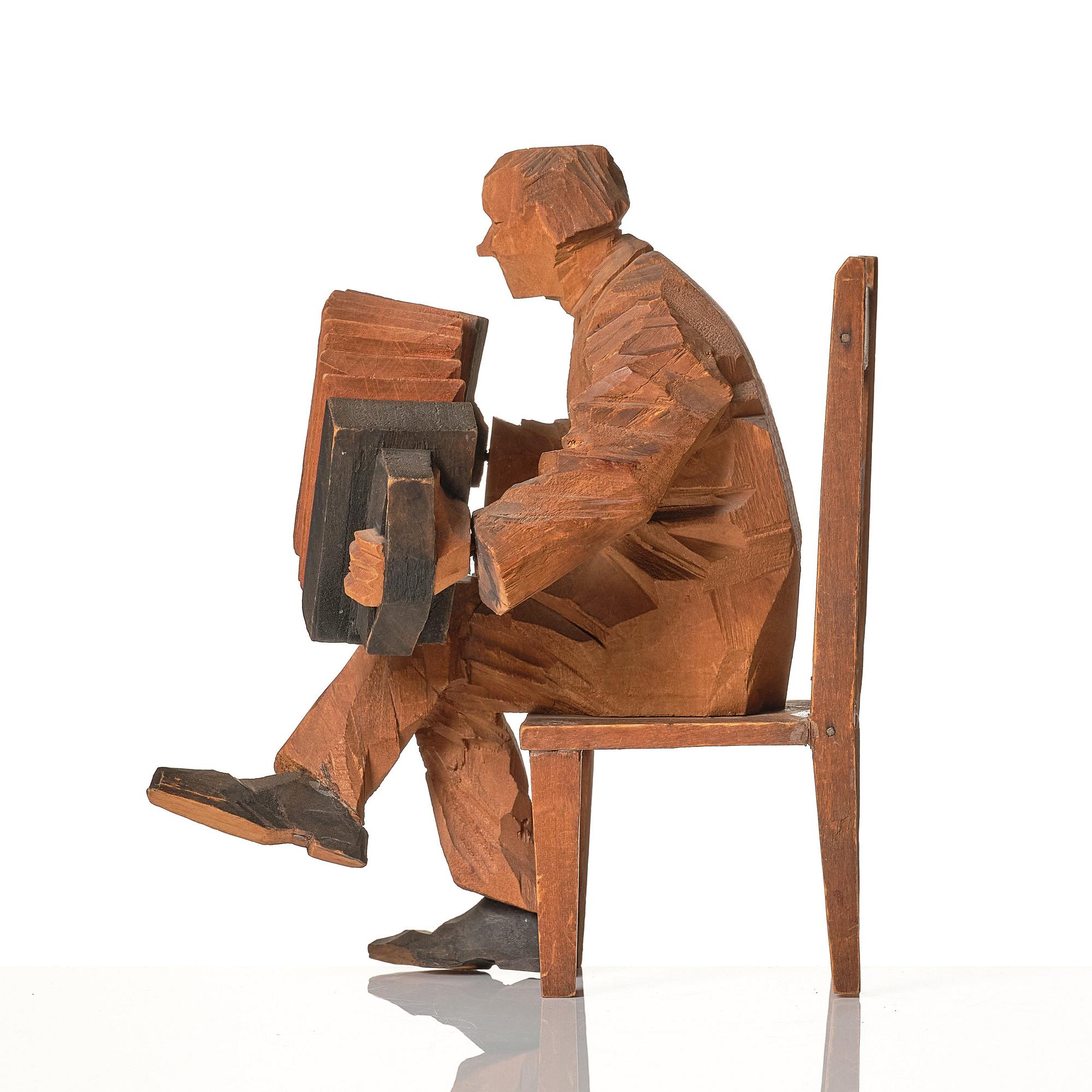 Axel Petersson Döderhultarn, Seated accordionist.