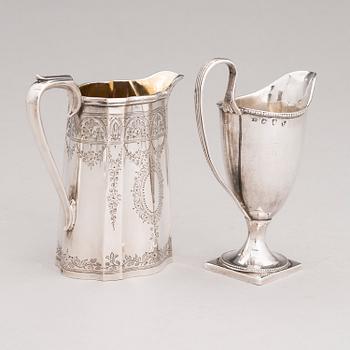 Two sterling silver milk jugs, mark of Thomas Hyde 1783 and Walter & John Barnard 1877, London.