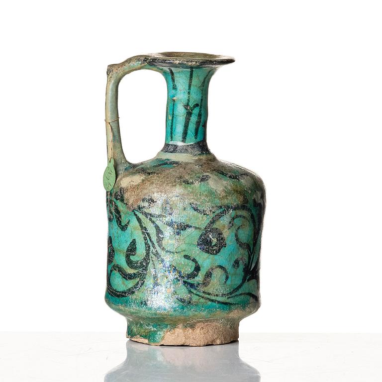 A Kashan turquoise blue-glazed ewer, central Persia (Iran), 11th to 12th century.