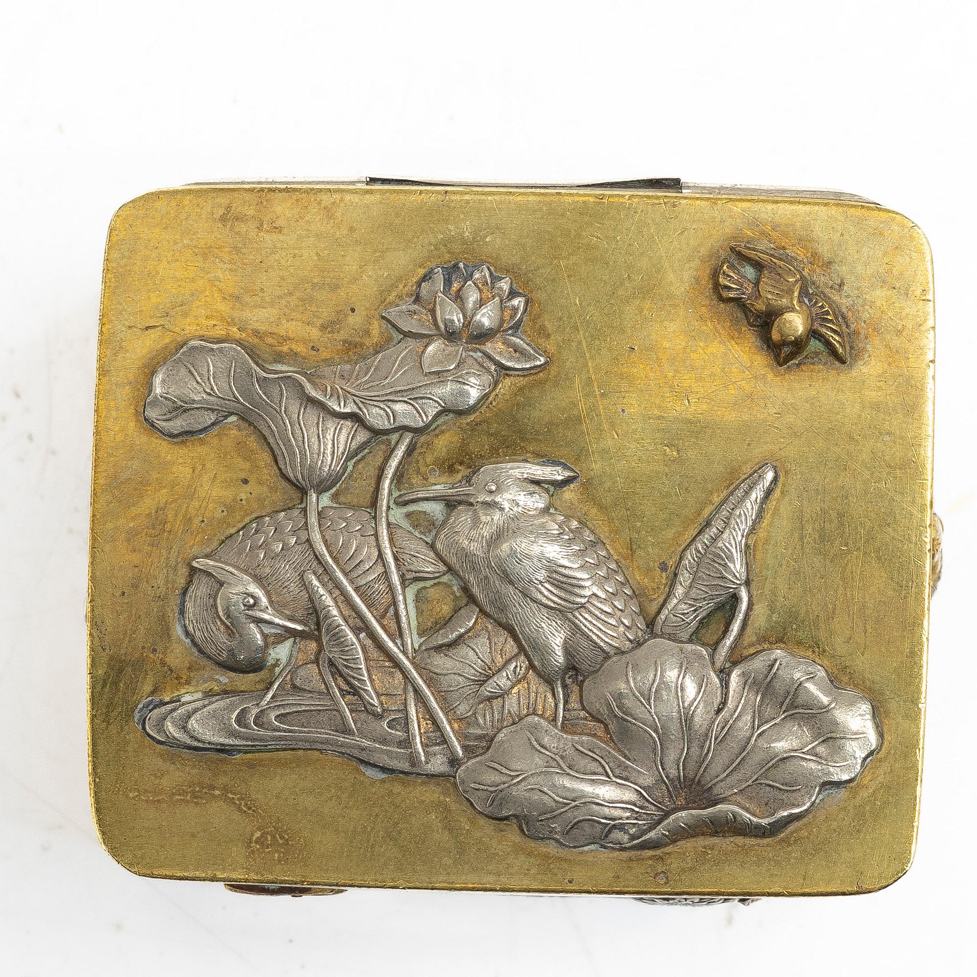 A small Japanese gilt copper box with cover and a porcelain dish, 19th century.