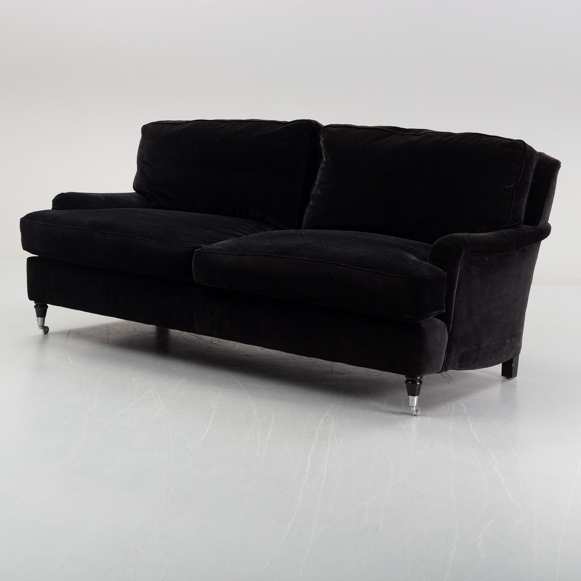 A contemporary velvet Howard sofa.