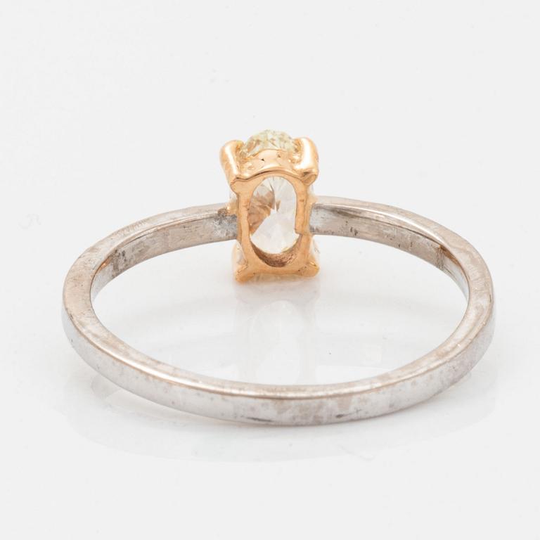 Oval diamond and brilliant-cut diamond ring.