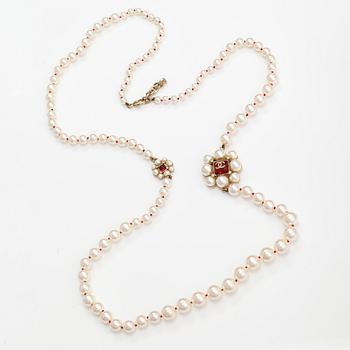 Chanel, A pearl collier with plastic pearls, glass stones and gold coloured metal parts. Marked Chanel, Made in France.