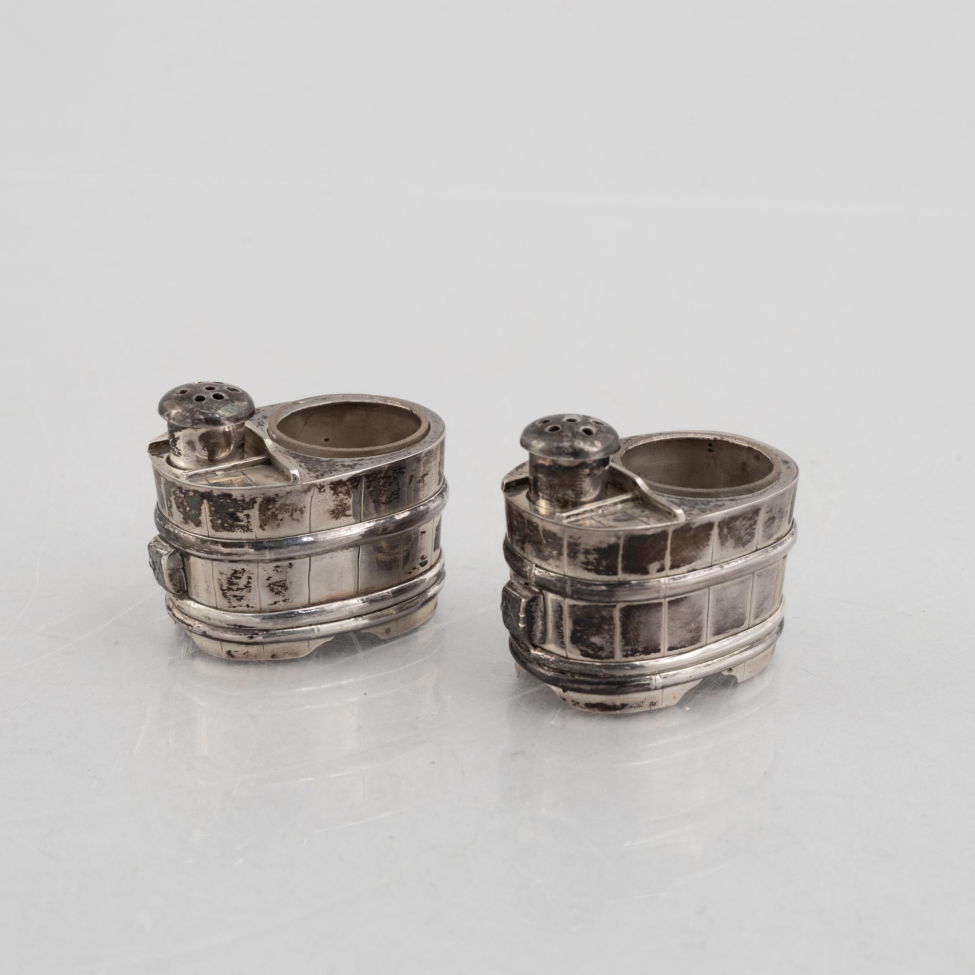 A set of three Japanese silver coasters and a pair of salts with shakers, 20th century.