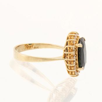 Ring in 14K gold with faceted sapphire and round brilliant-cut diamonds.