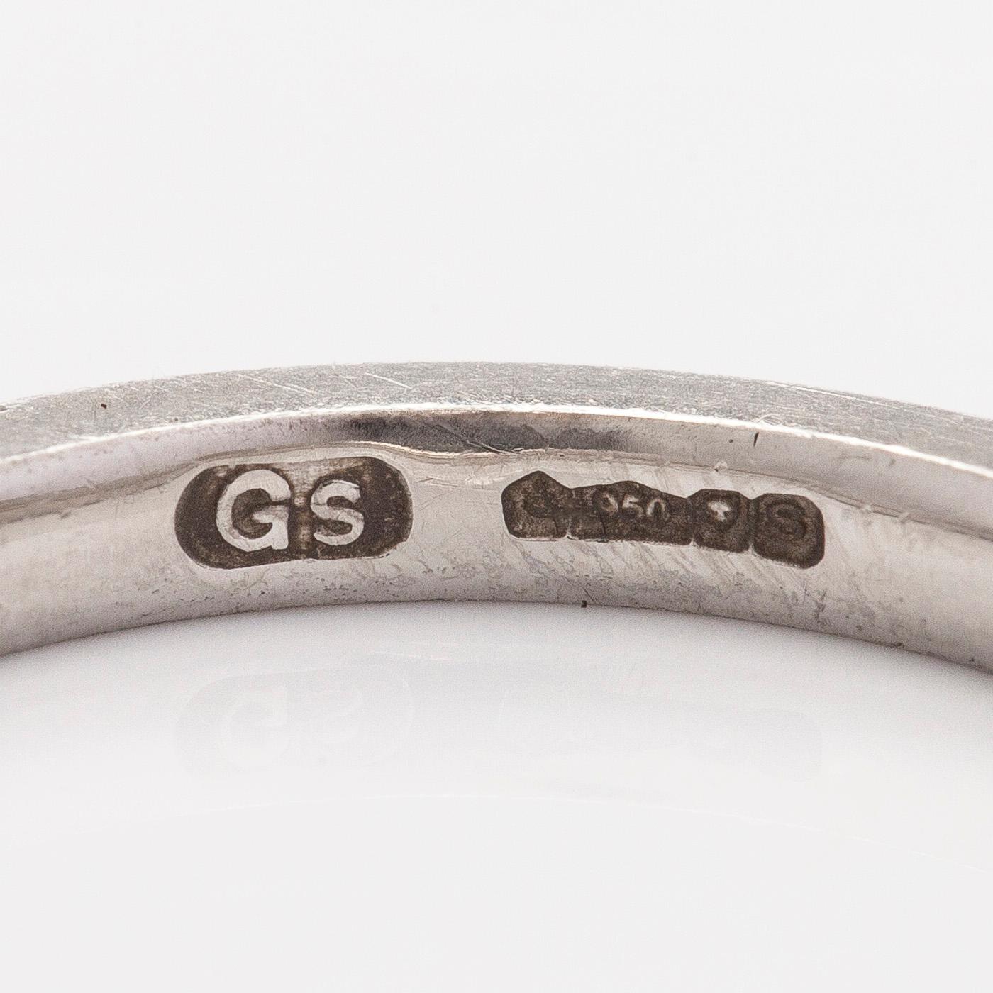 A platinum ring with brilliant cut diamonds.