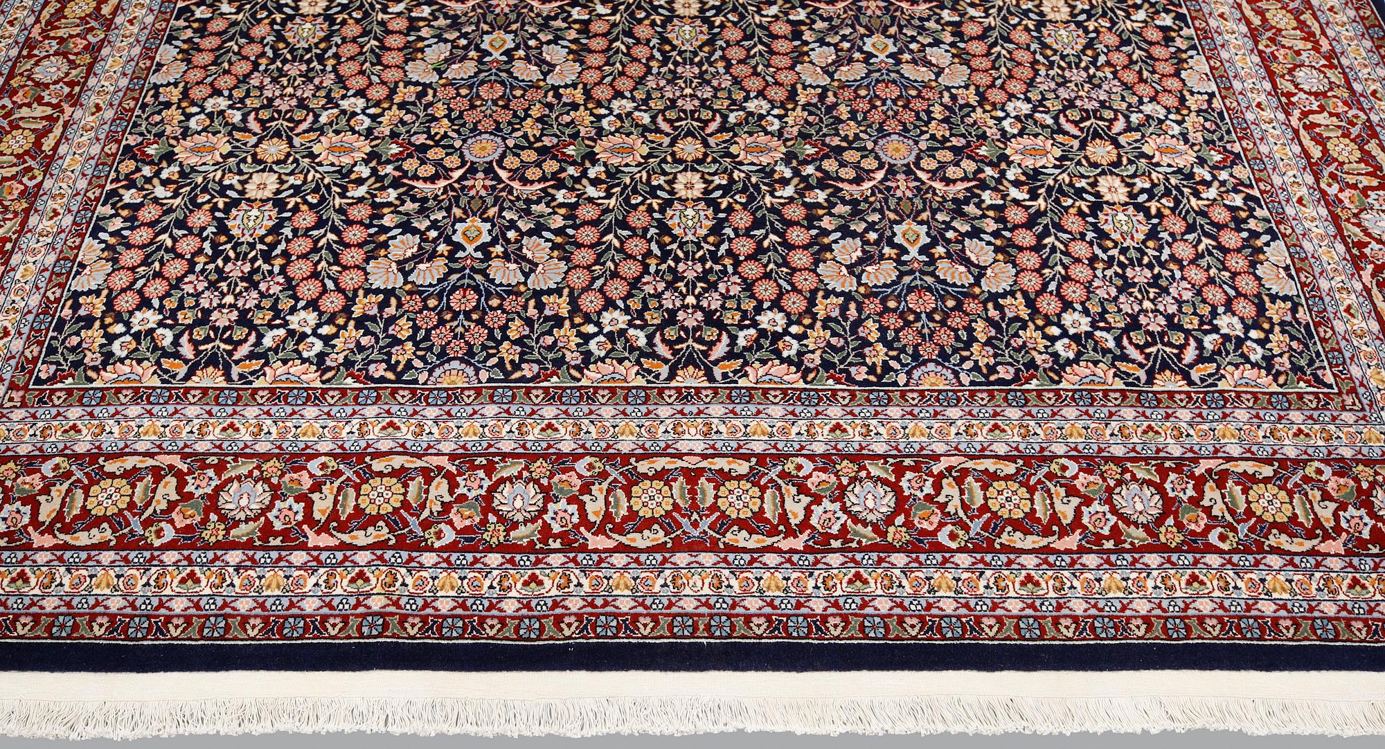 A signed Hereke carpet, ca 340 x 246 cm.