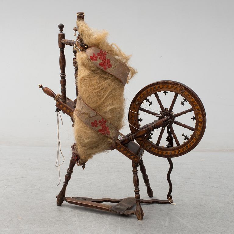 A 19th century spinning wheel.