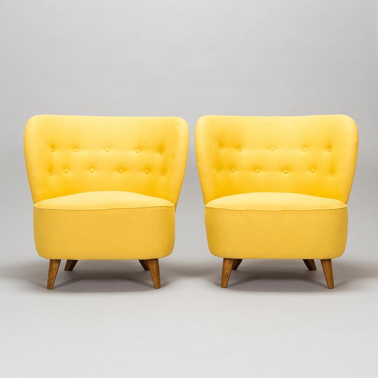 A pair of mid-20th-century armchairs.