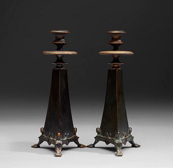 438. A pair of Melchior Wernstedt bronze candelsticks, foundry Herman Bergman AB.