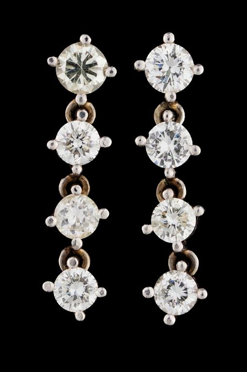 A pair of gold and diamond earrings.