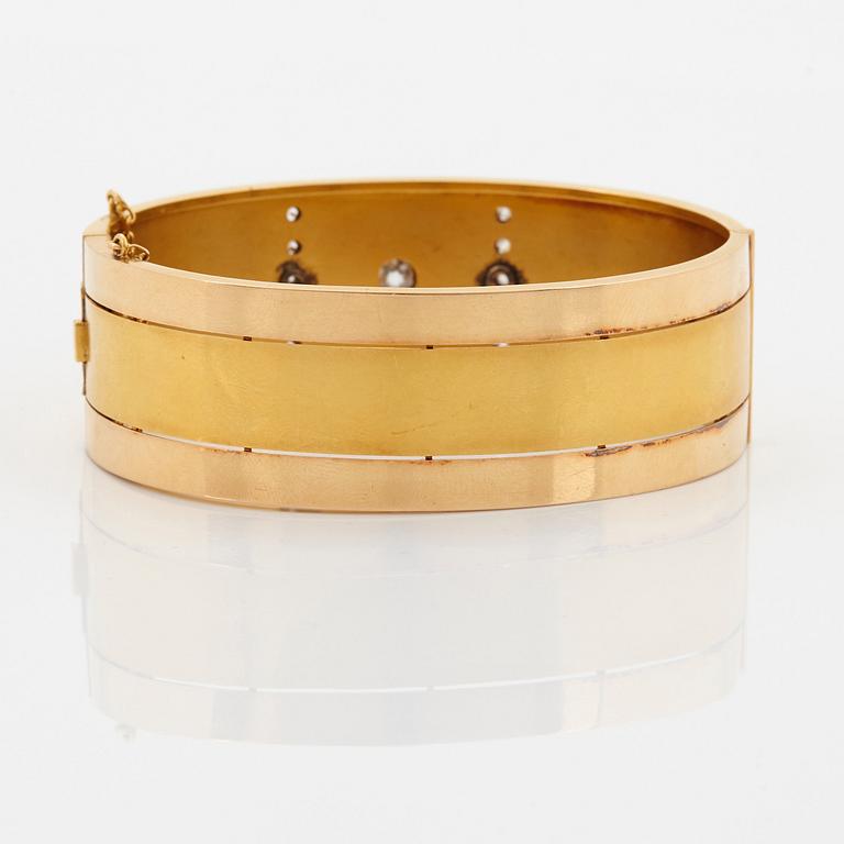 An 18K gold bracelet set with old-cut diamonds.