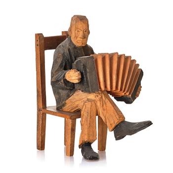 536. Axel Petersson Döderhultarn, Seated accordionist.