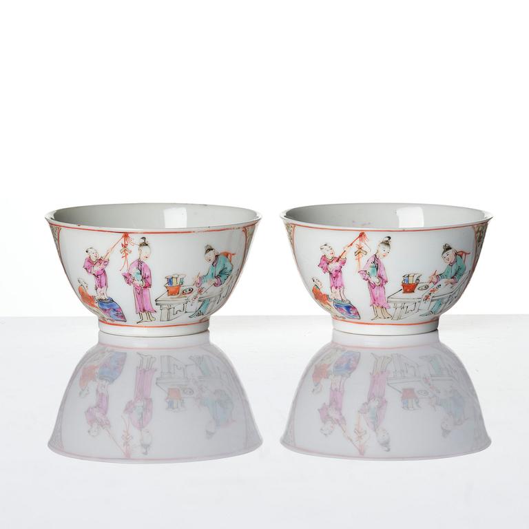A pair of famille rose 'figural' tea cups with saucers, Qing dynasty, Qianlong (1736-95).