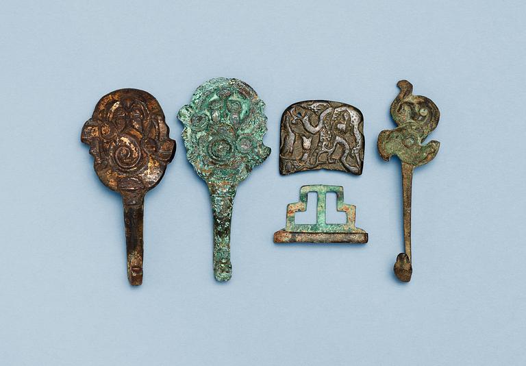 A set of four archaistic bronze garment hooks.