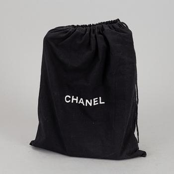 CHANEL, a quilted black leather 'Double Flap Bag'.