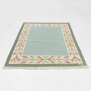 A flat weave carpet, signed TE, c. 224 x 126 cm.