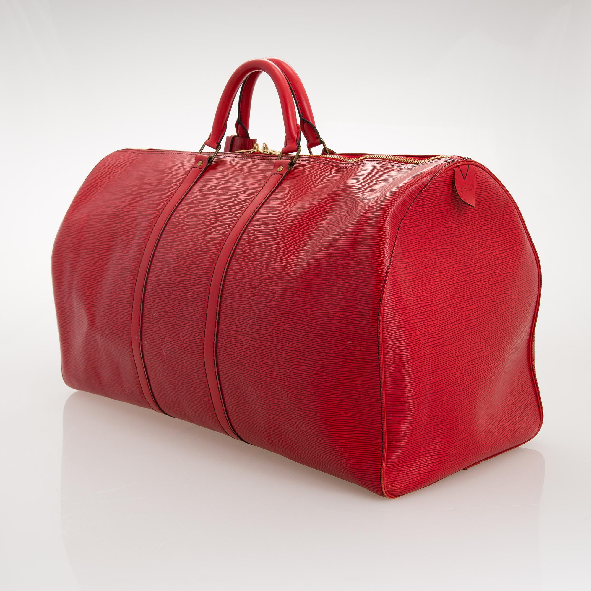 A RED EPI LEATHER KEEPALL TRAVEL BAG.