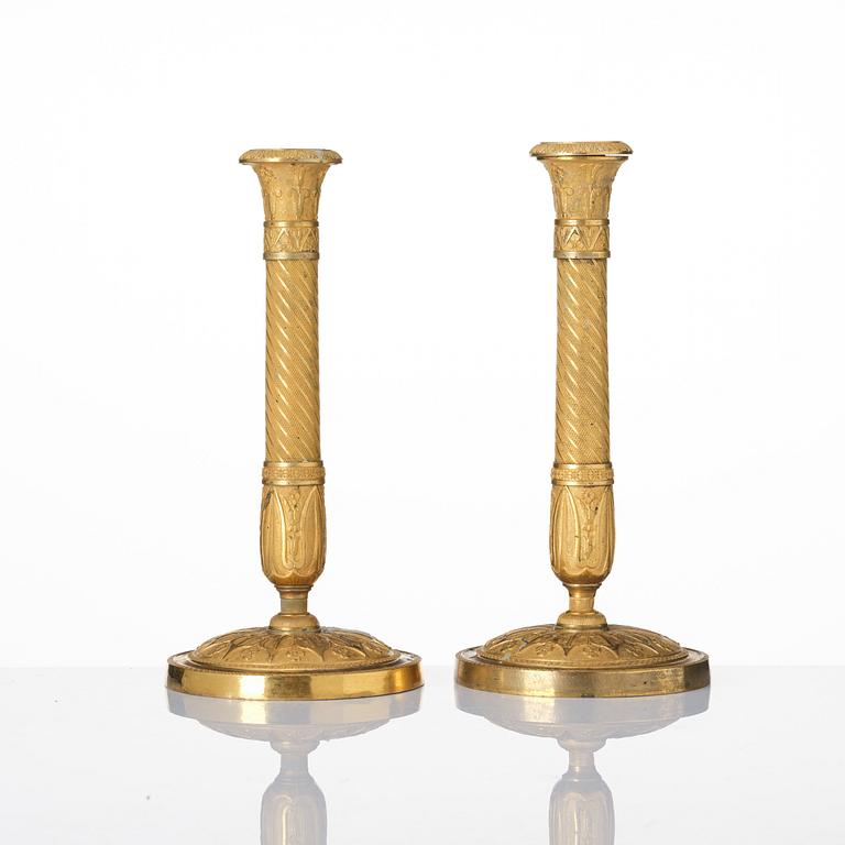 A pair of French Empire ormolu candlesticks, Paris, early 19th century.