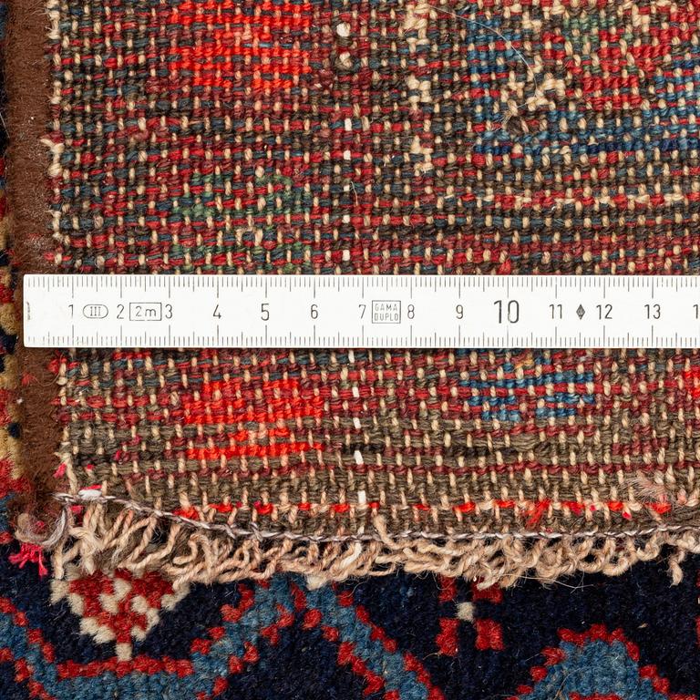 A carpet, semi-antique kurdish, circa 300 x 147 cm.