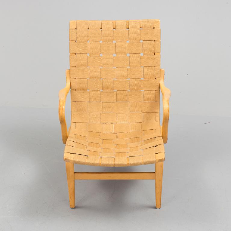 an "Eva" armchair by BRUNO MATHSSON 1963.
