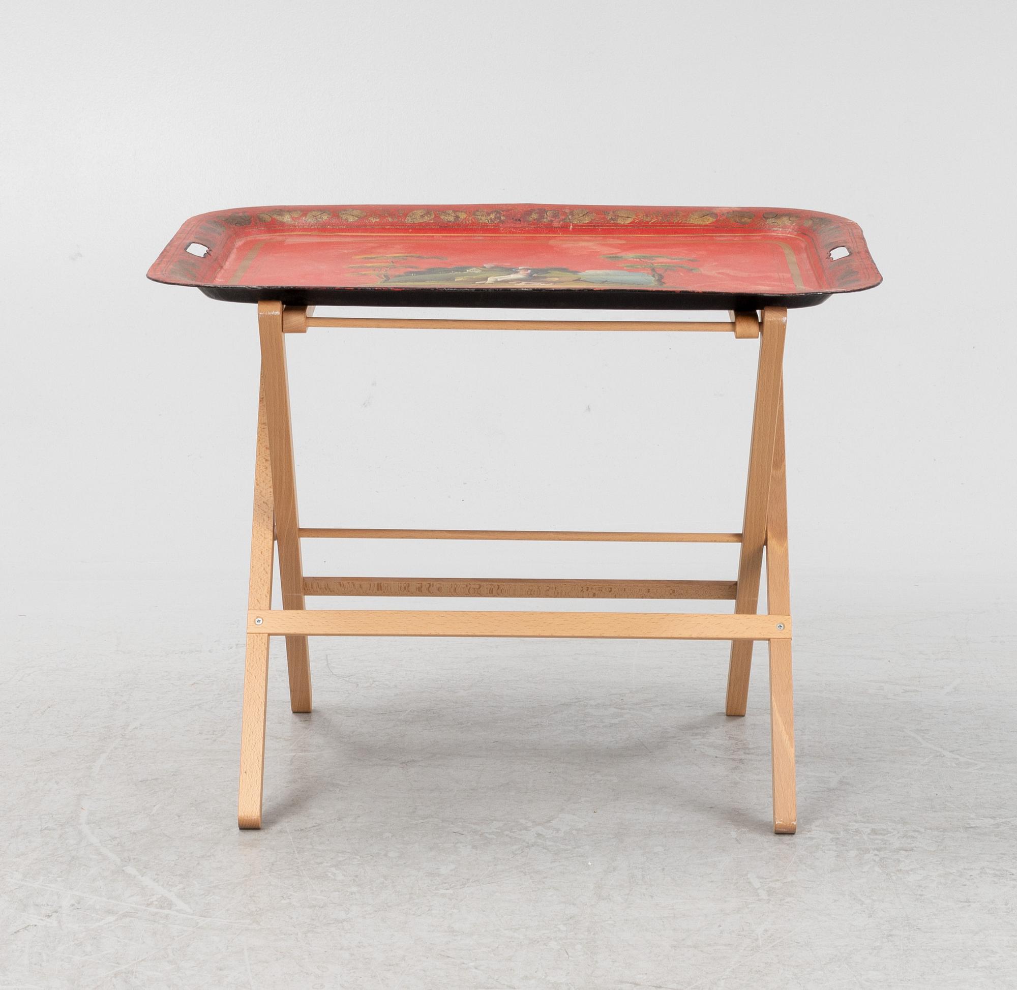 A painted 19th Century tin tray with later stand.