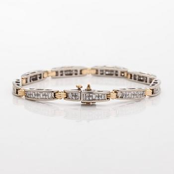 A 14K gold/white gold bracelet set with princess- and baguette-cut diamonds.