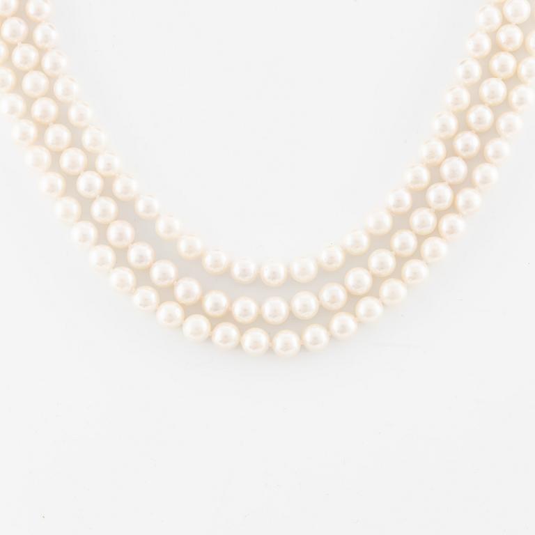 Necklace, pearls, three strands, clasp in 14K white gold with small diamonds.