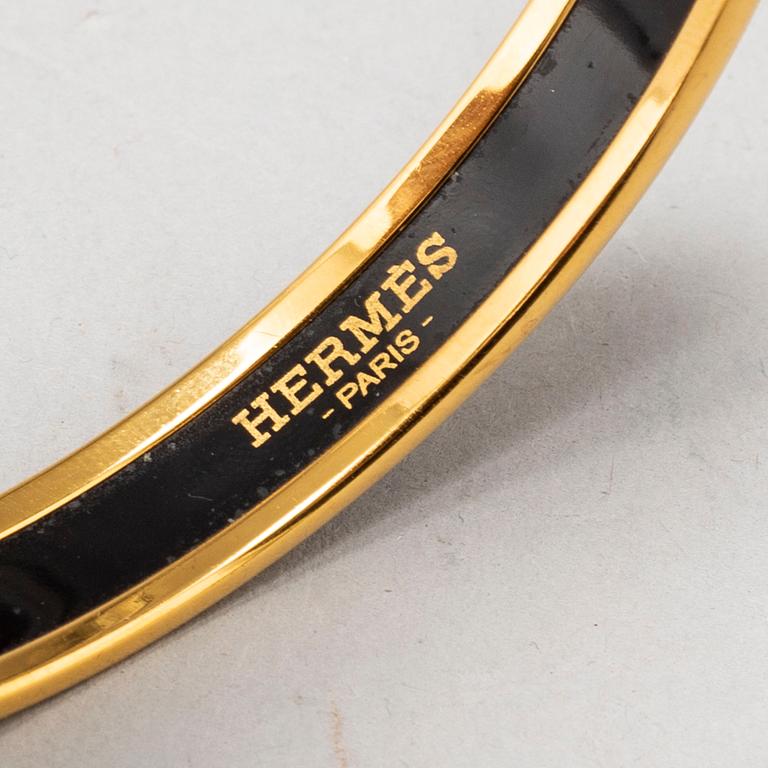 HERMÈS, a metal and enamel bangle.