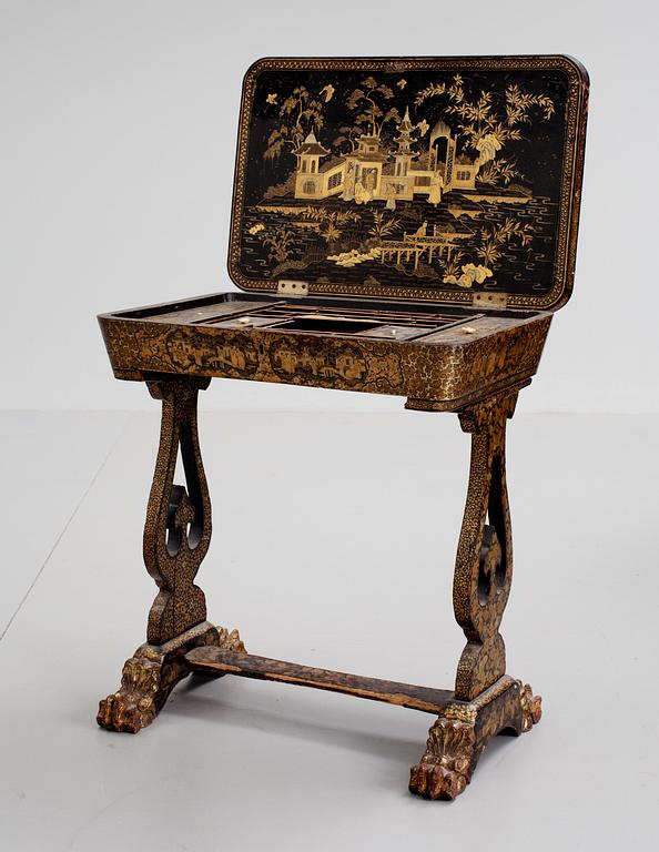 A gold and black lacquer sewing table, Qing dynasty, ca 1800.