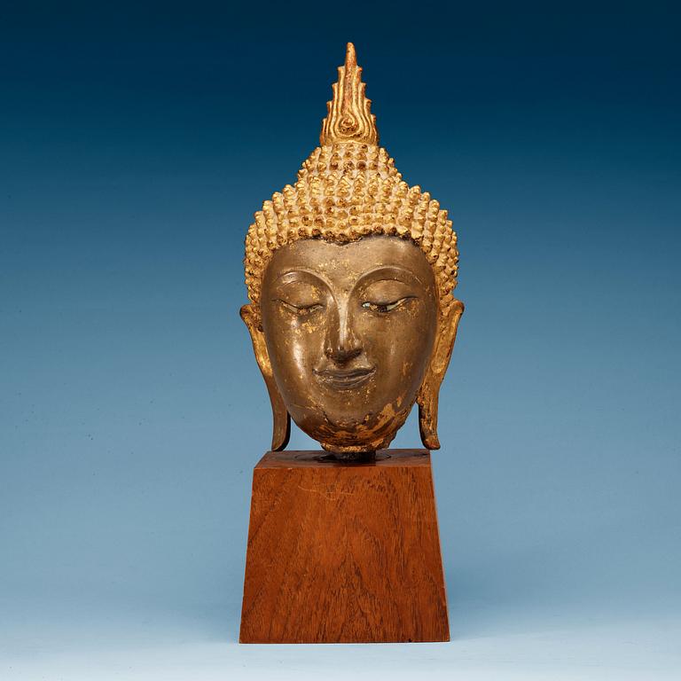 A gilt bronze head of Buddha, Thailand, 19th Century.