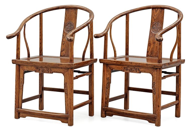 A pair of hardwood horseshoeback armchairs, Qing dynasty.